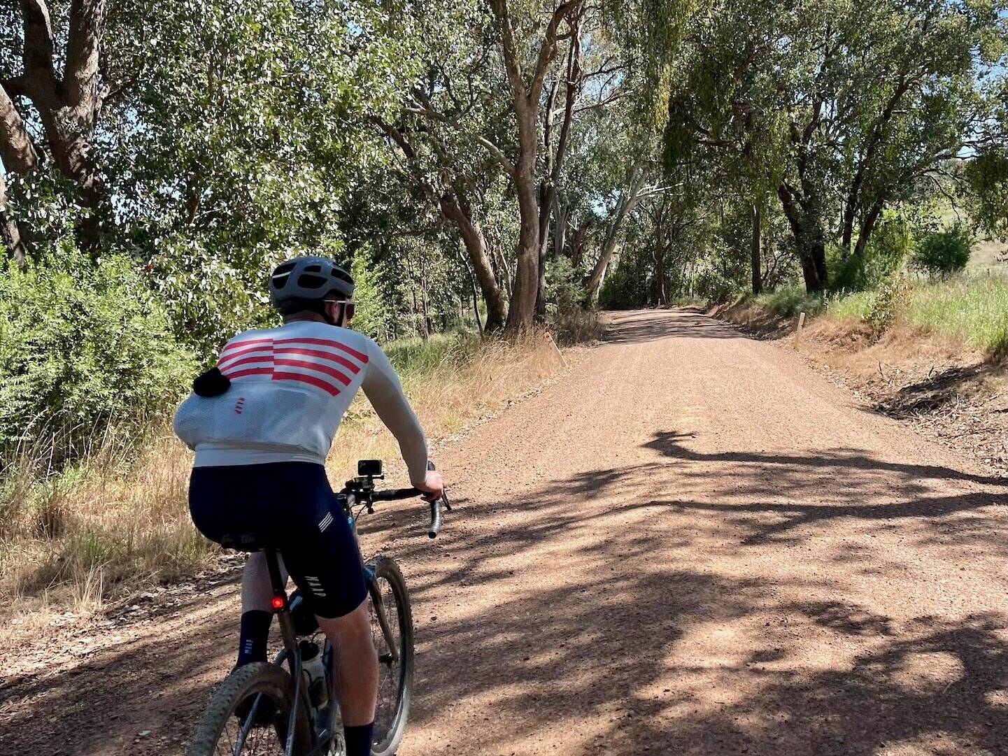 Gravel riding beside open farmland