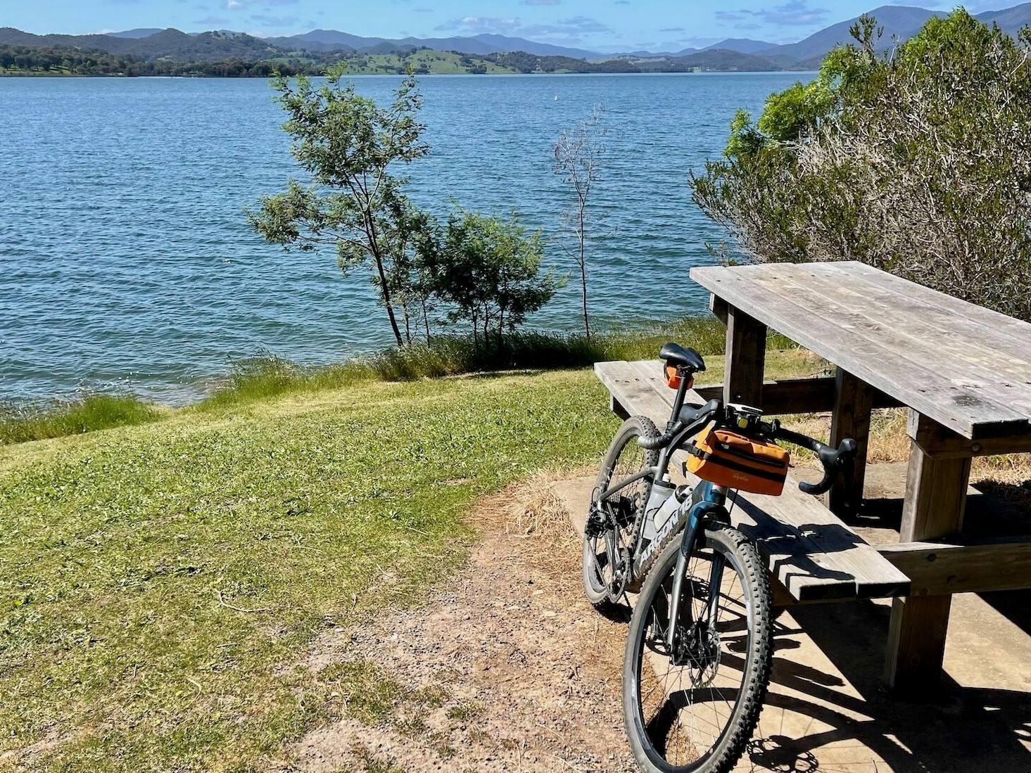 Gravel bike leaning against picnic table at Lake Eildon