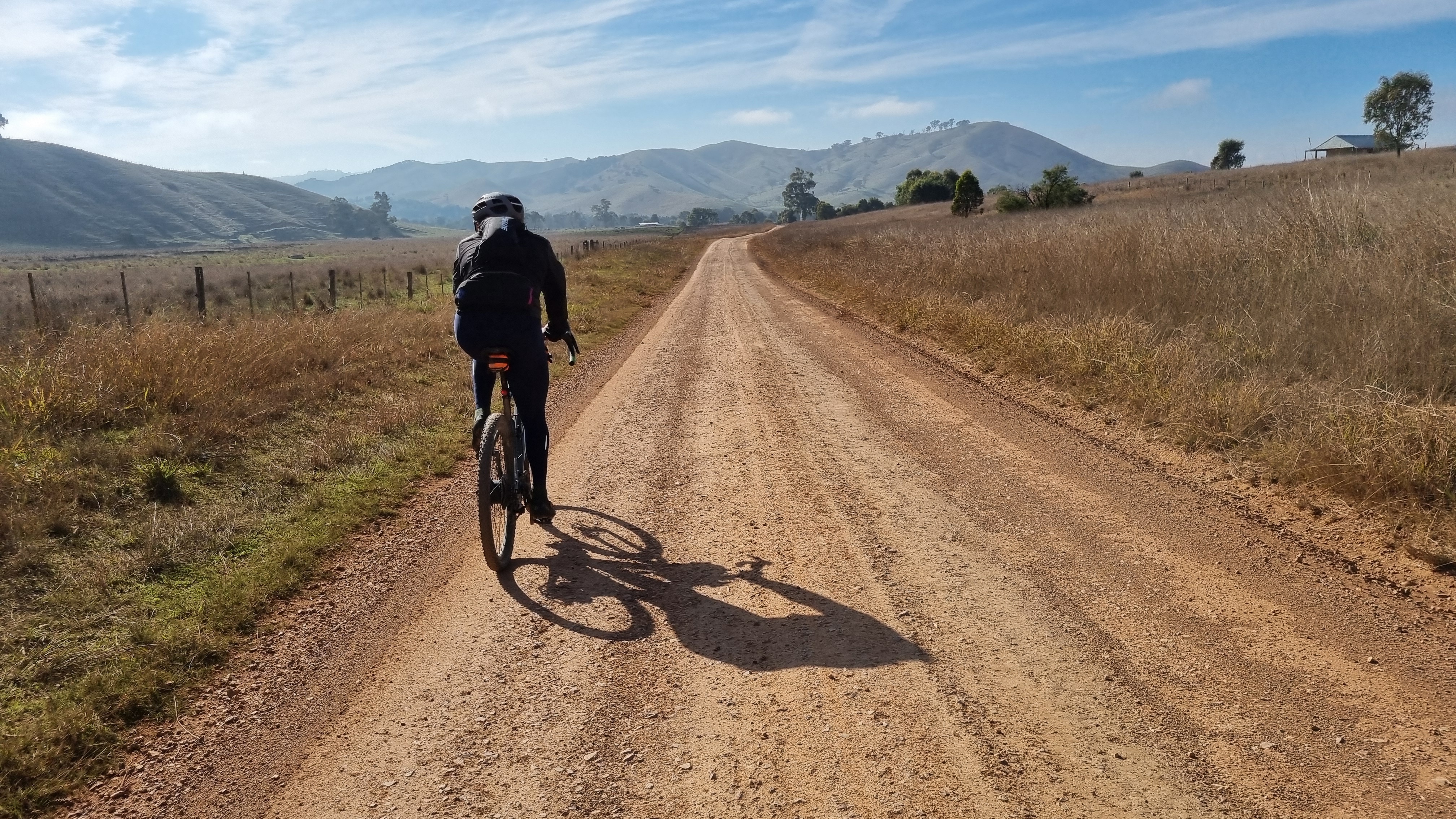 Cyclist riding the Goin to Bonnie Doon gravel route towards hills