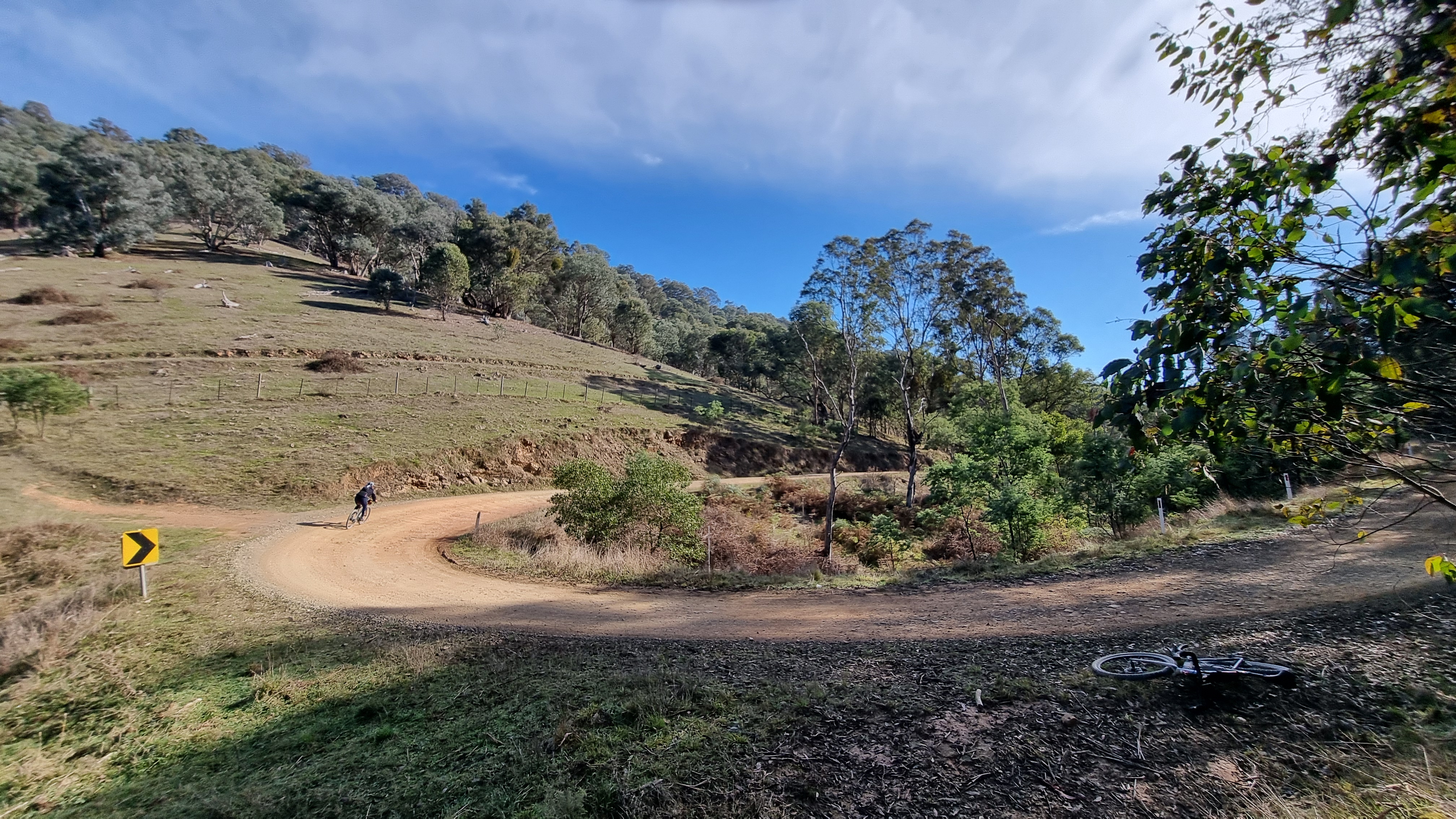 Gravel cyclist riding bends in the road on the Goin to Bonnie Doon gravel route