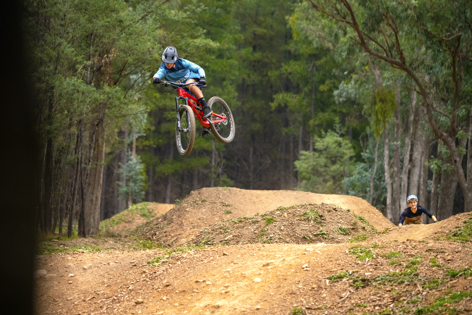 Mountain biker sending it over jumps at Mystic Bike Park