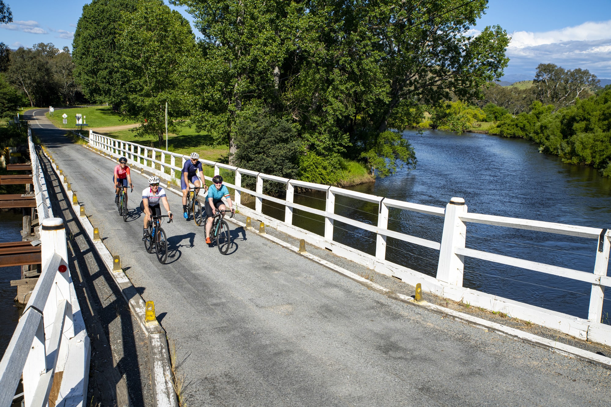 Group of cyclists riding the Border Loop road route over the Murray River on the Tintaldra Bridge