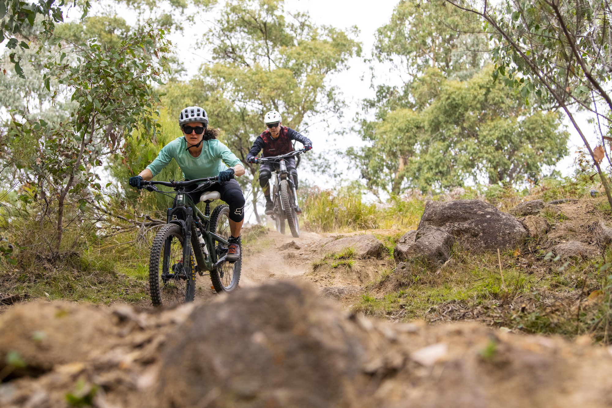 Two cyclists riding technical rock features at Big Hill Mountain Bike Park