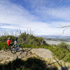 Two cyclists enjoying the view at Lake Mountain Bike Park