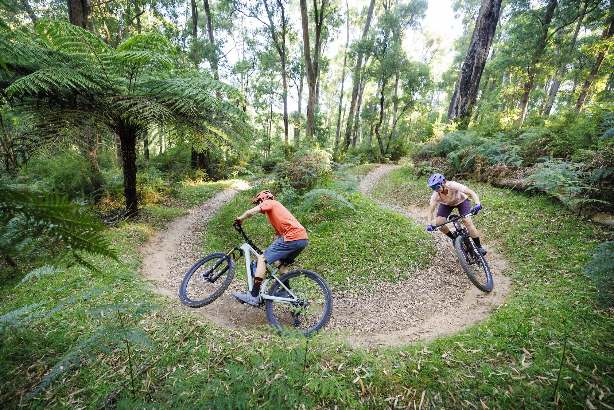 Two cyclists riding flowing corners at Buxton Mountain Bike Park