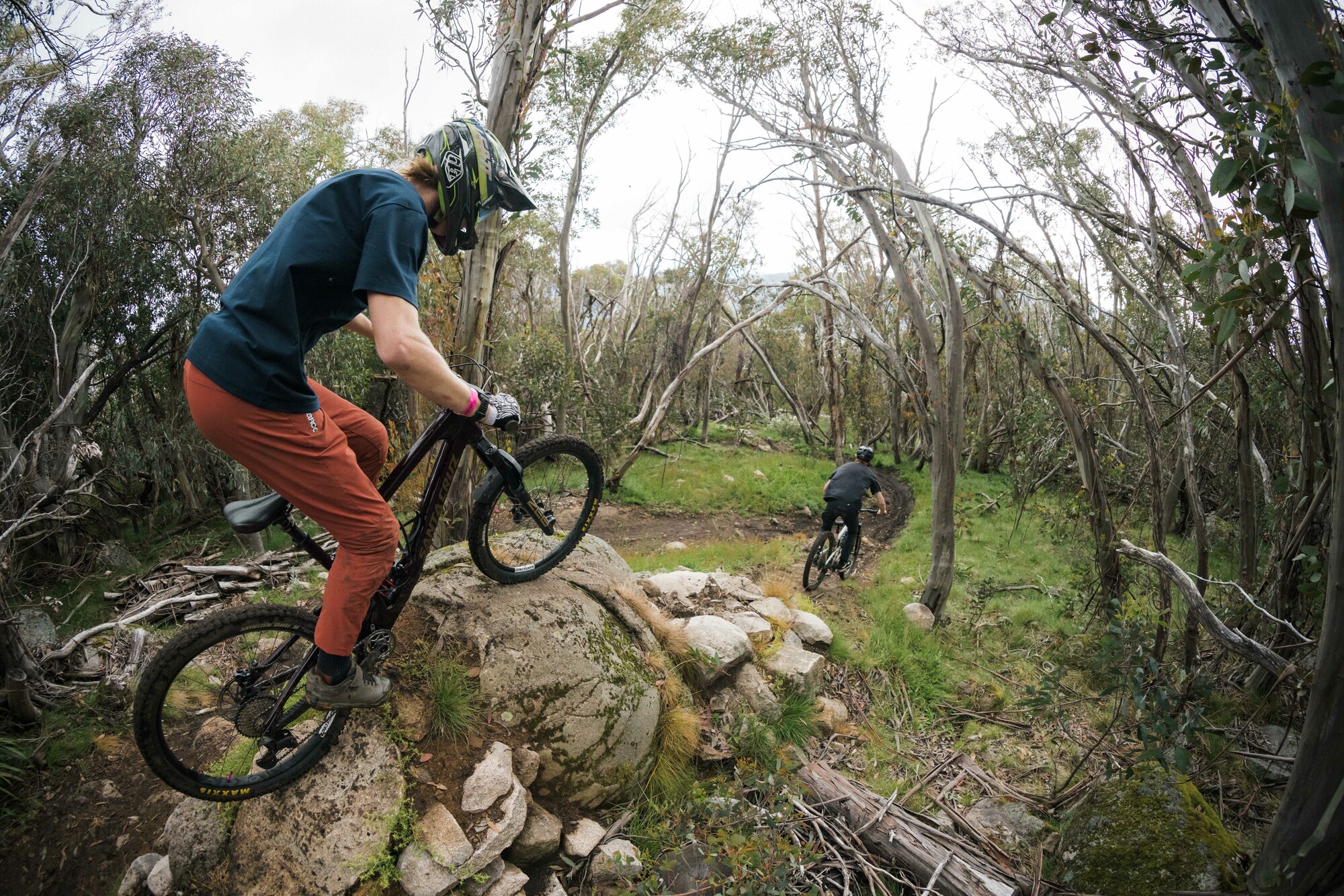 Gravity mountain bikers riding rock features at Mt Buller Bike Park