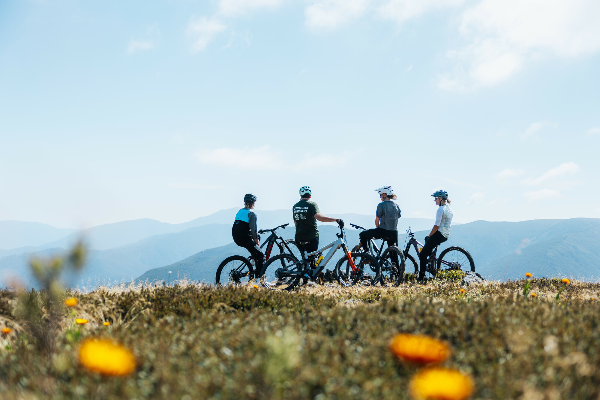 A group of cyclists admiring the views at Falls Creek Mountain Bike Park