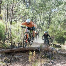 A group of riders taking on technical features at Big Hill Mountain Bike Park