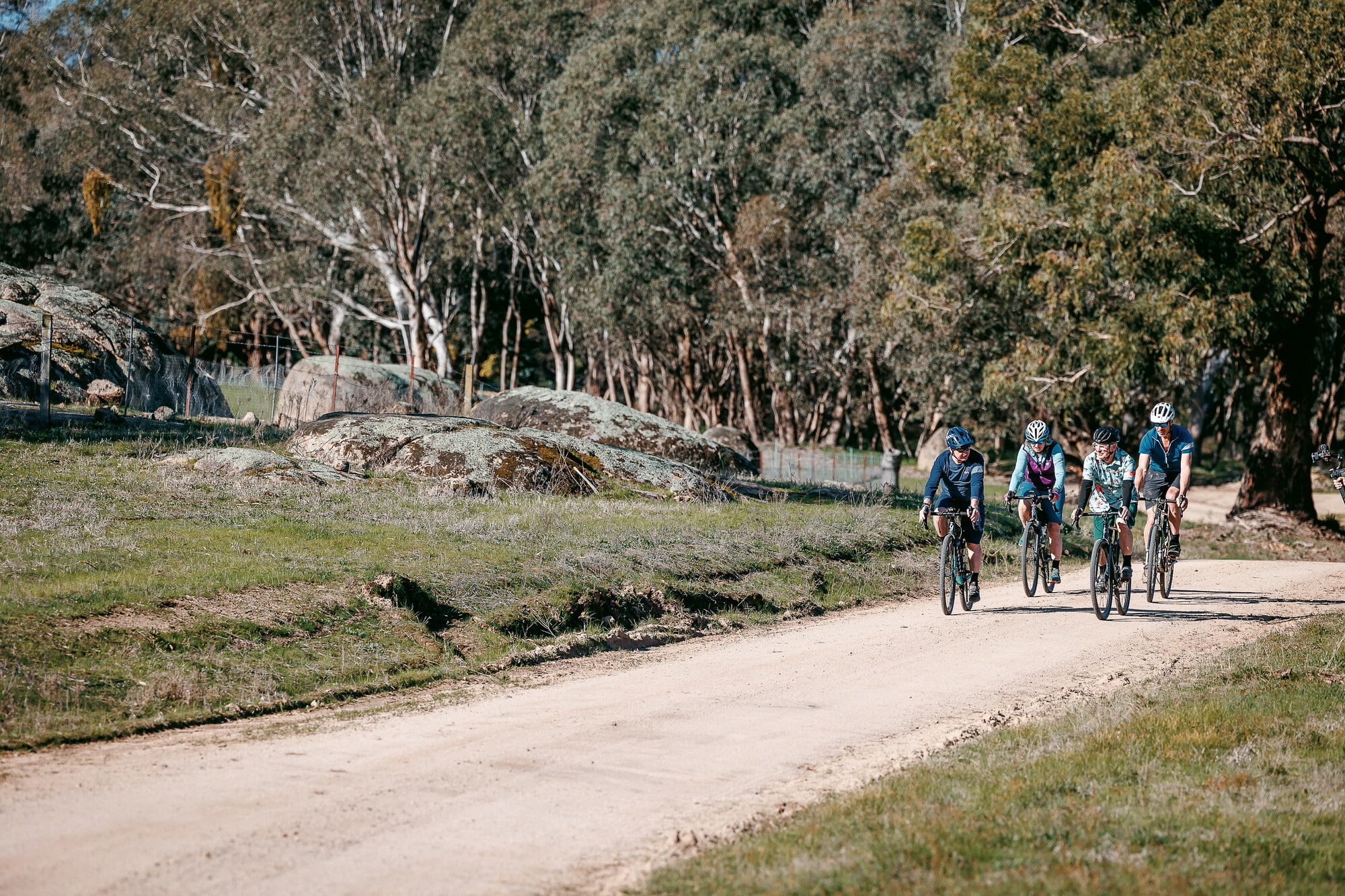Gravel riding on smooth gravel road past large exposed rock outcrop