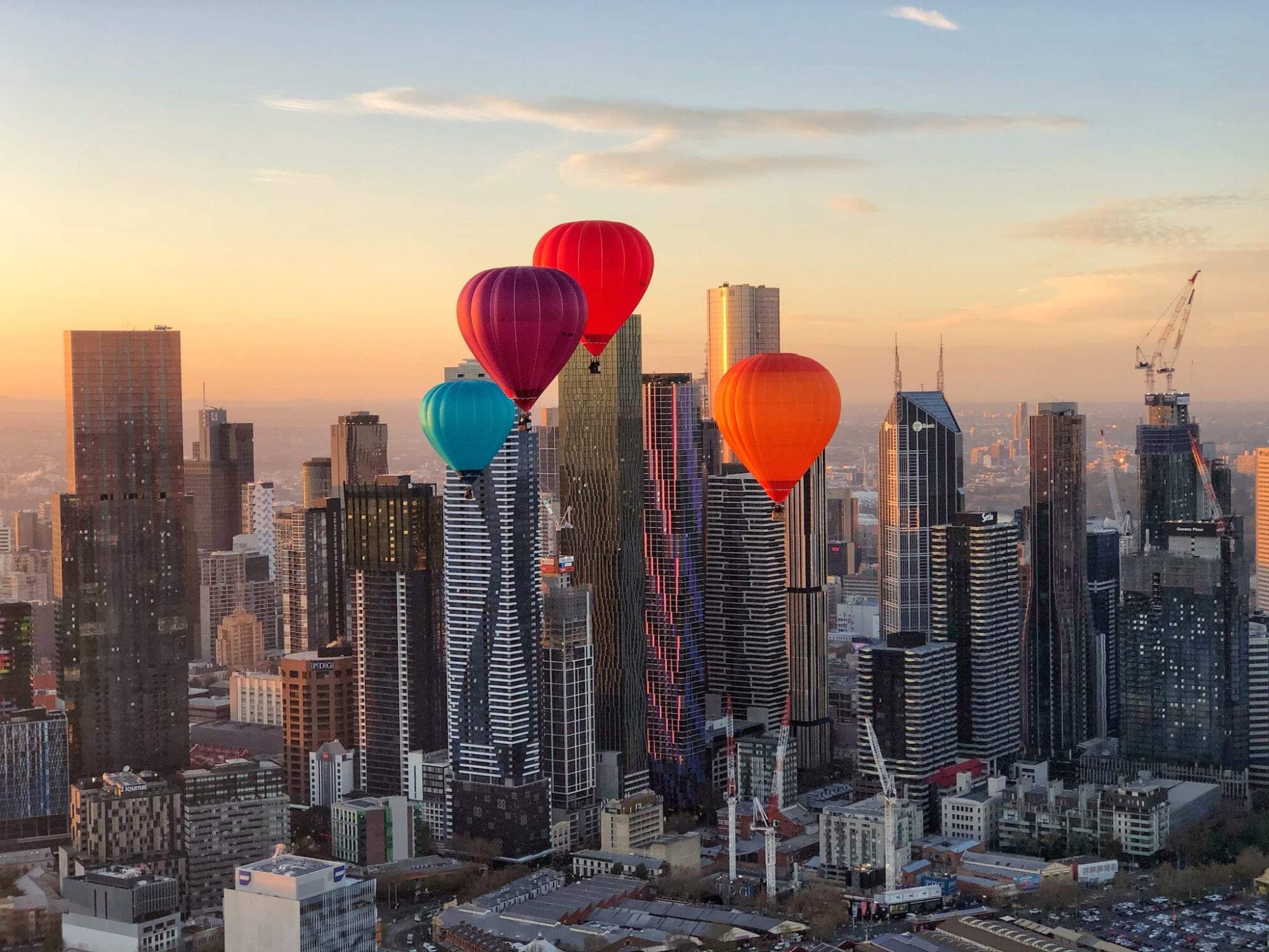 4 coloured balloons over the Melbourne CBD