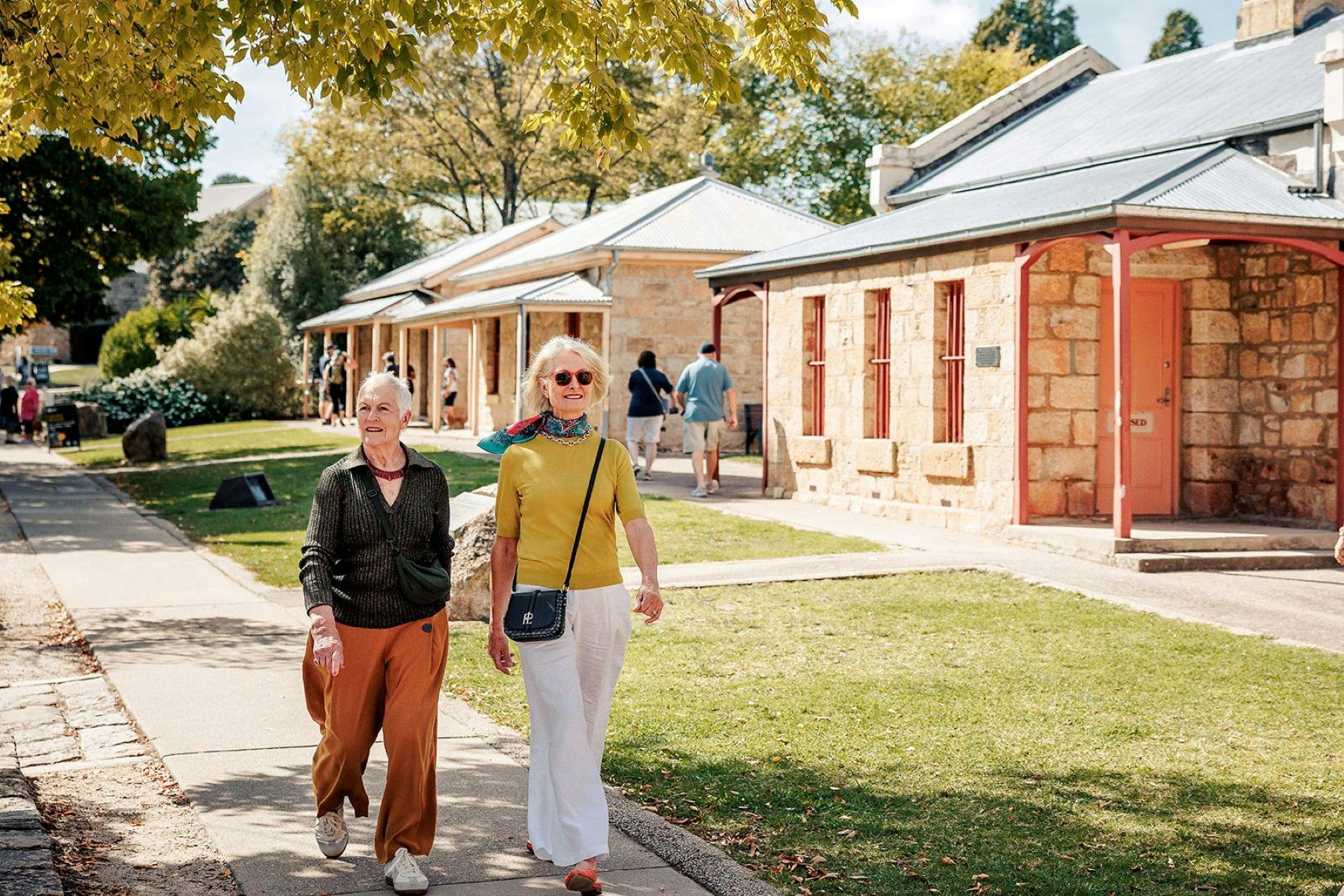 Two women walking in front of the Beechworth Historic Precinct