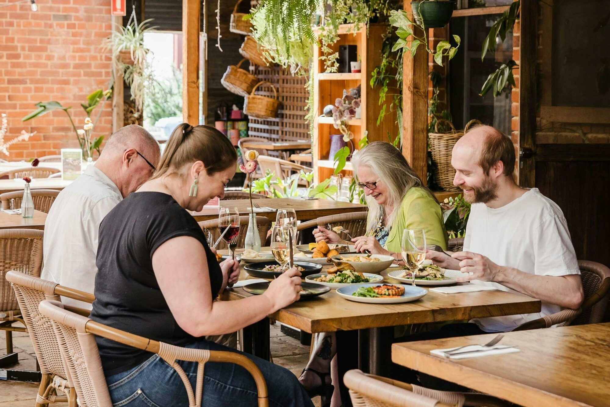 laughing around the table in the enclosed courtyard at Pickled Sisters