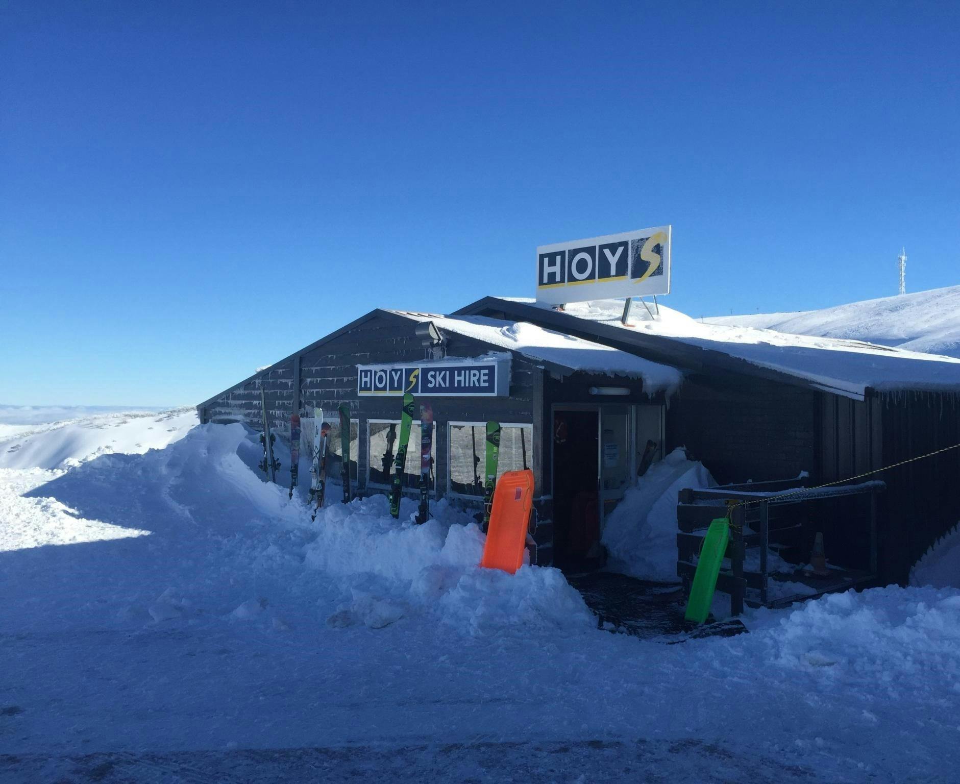 Hoys Hotham Ski Shop on a sunny day  with lots of snow