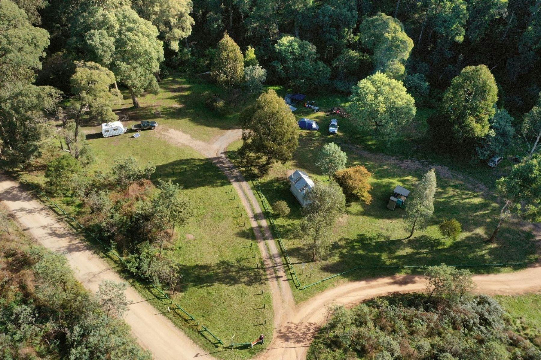 An aerial view of James Reserve showing trees, grass and campers.