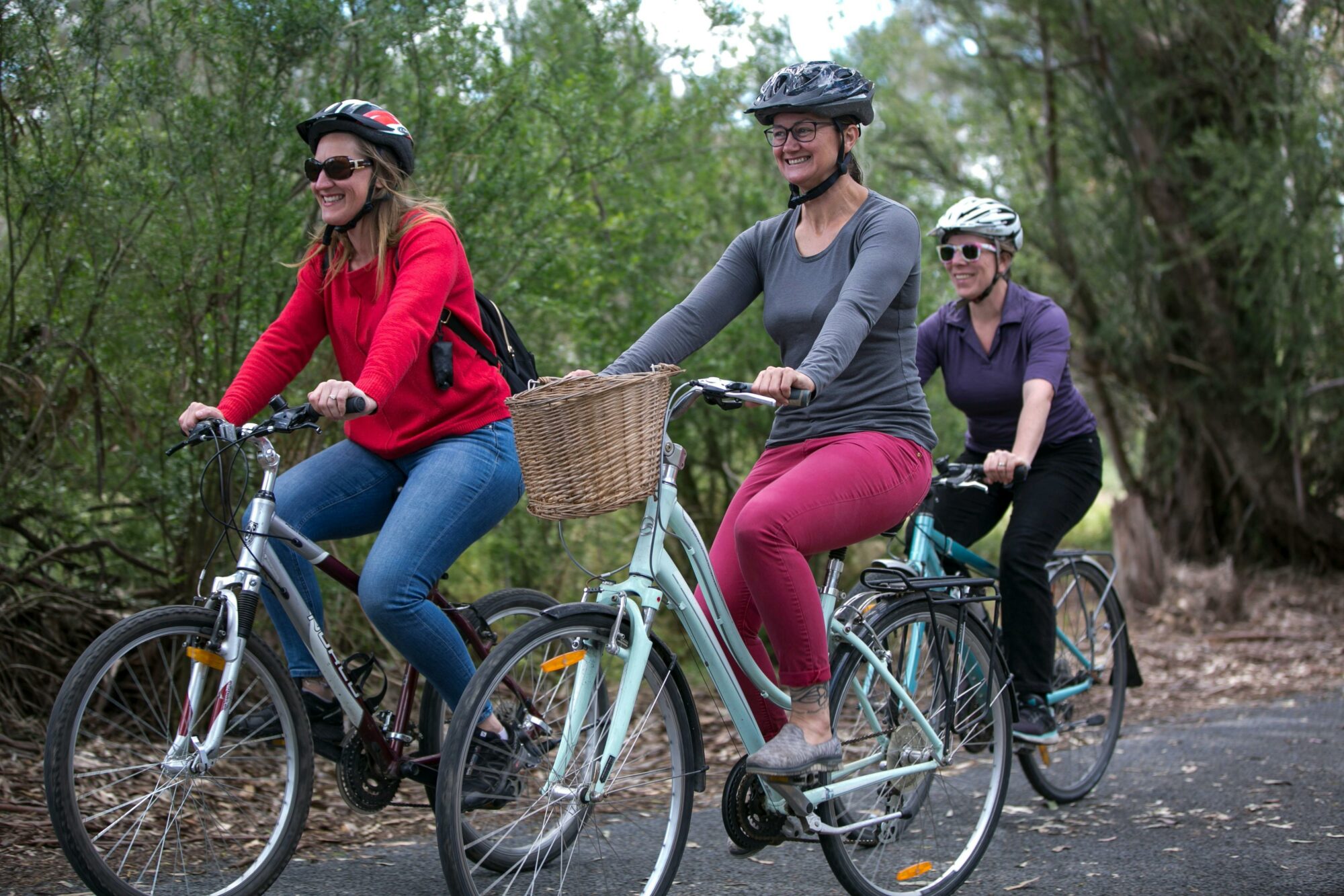 Three women riding along a trail