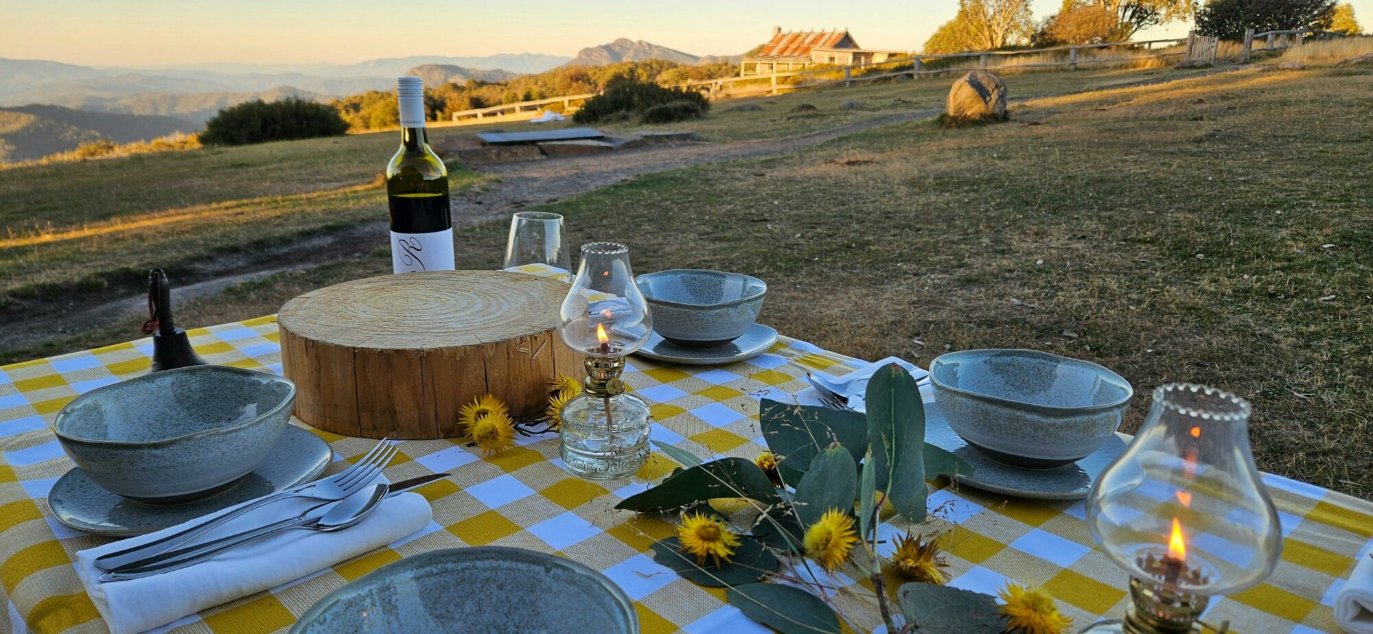 Table setting with Craig's Hut in the background.