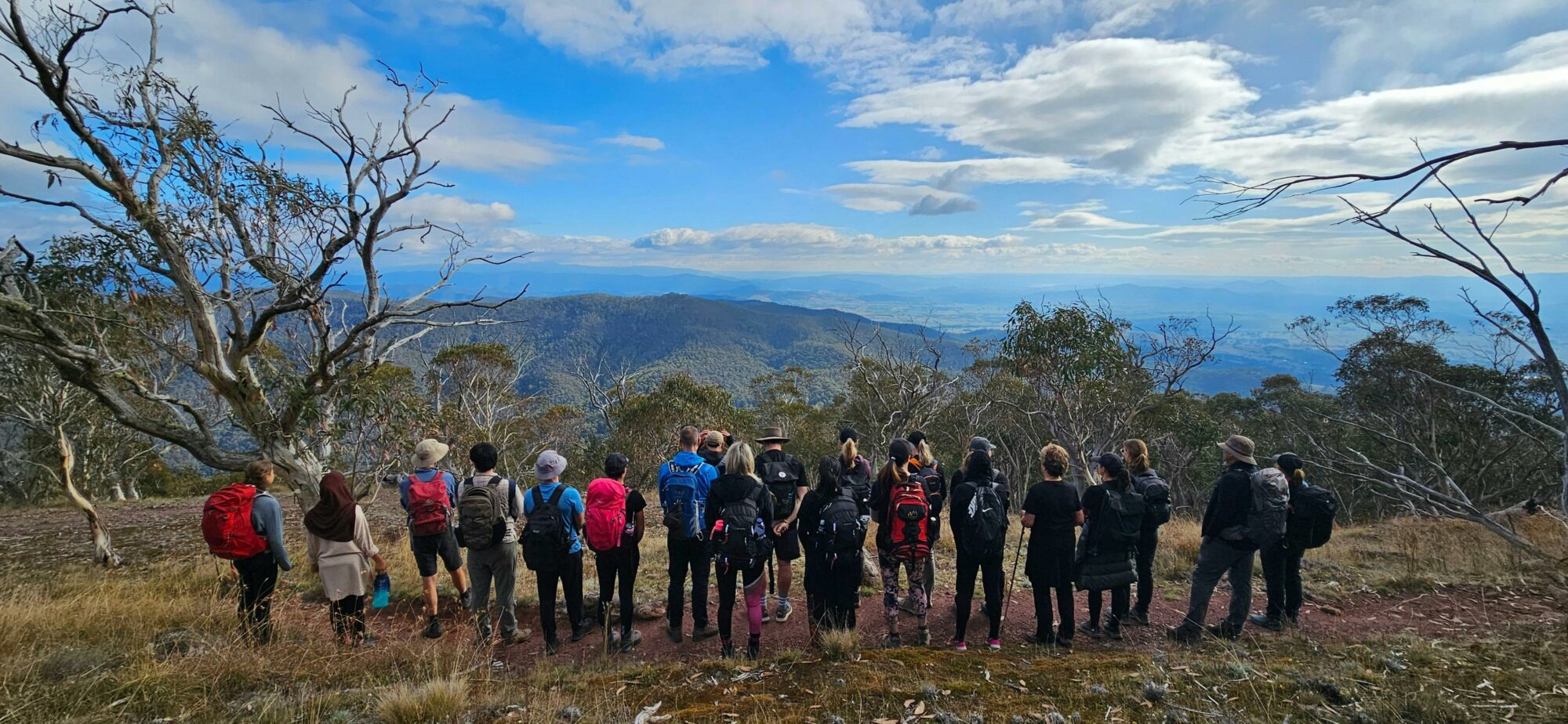 A group of hikers are soaking up the views of the Delatite Valley.