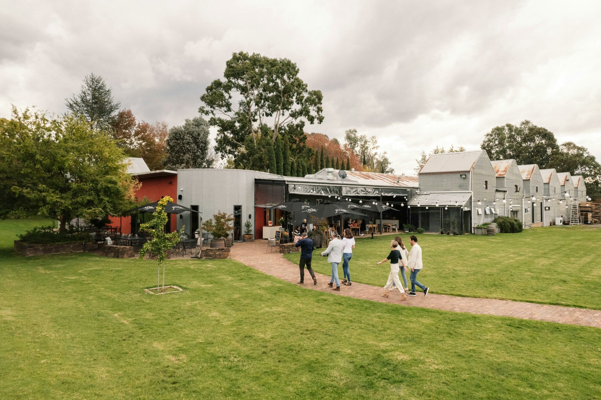 Six guests walking into Pizzini Cellar Door