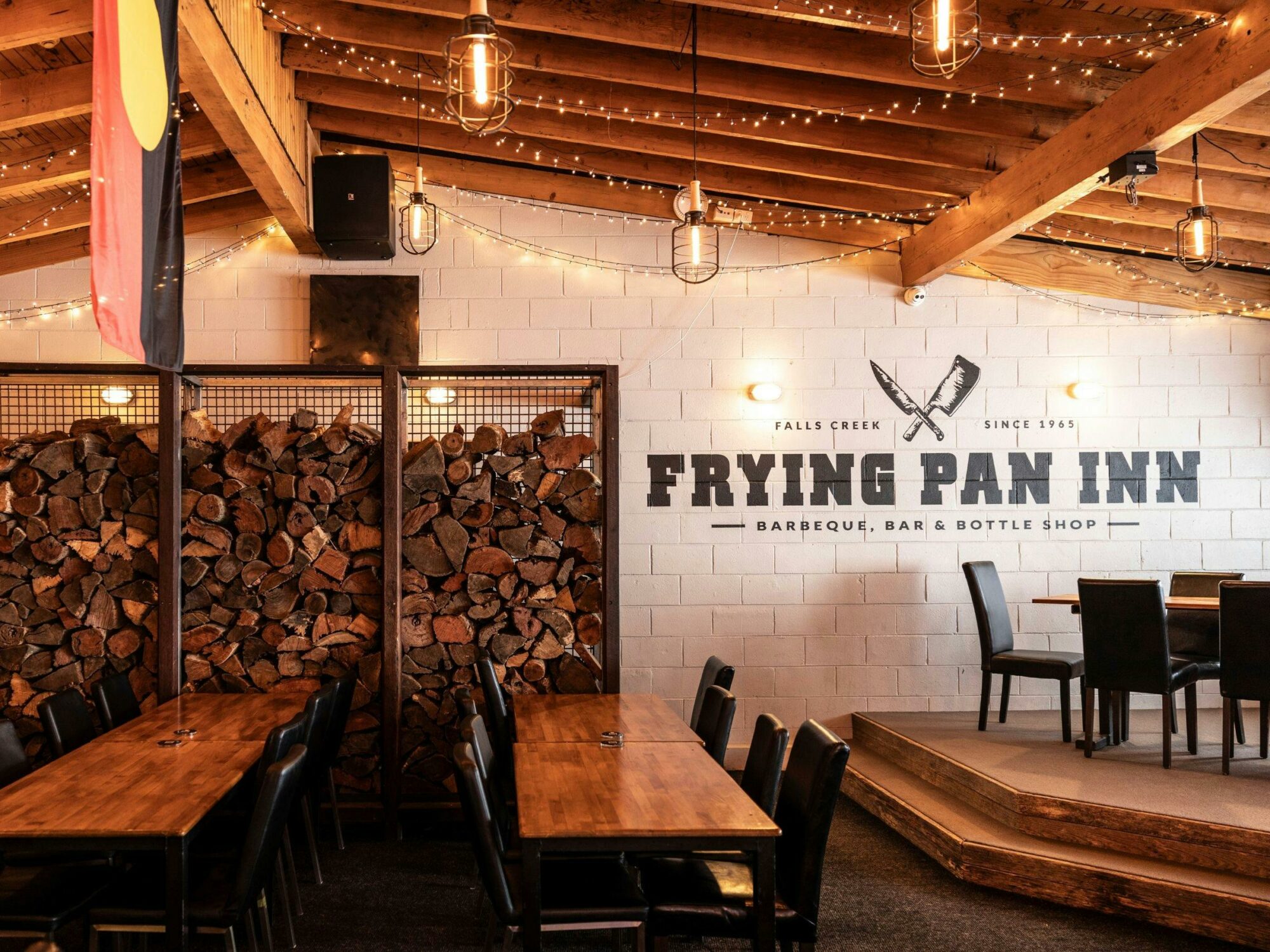 An image of the interior dining area at Frying Pan Inn featuring firewood used for open fireplaces