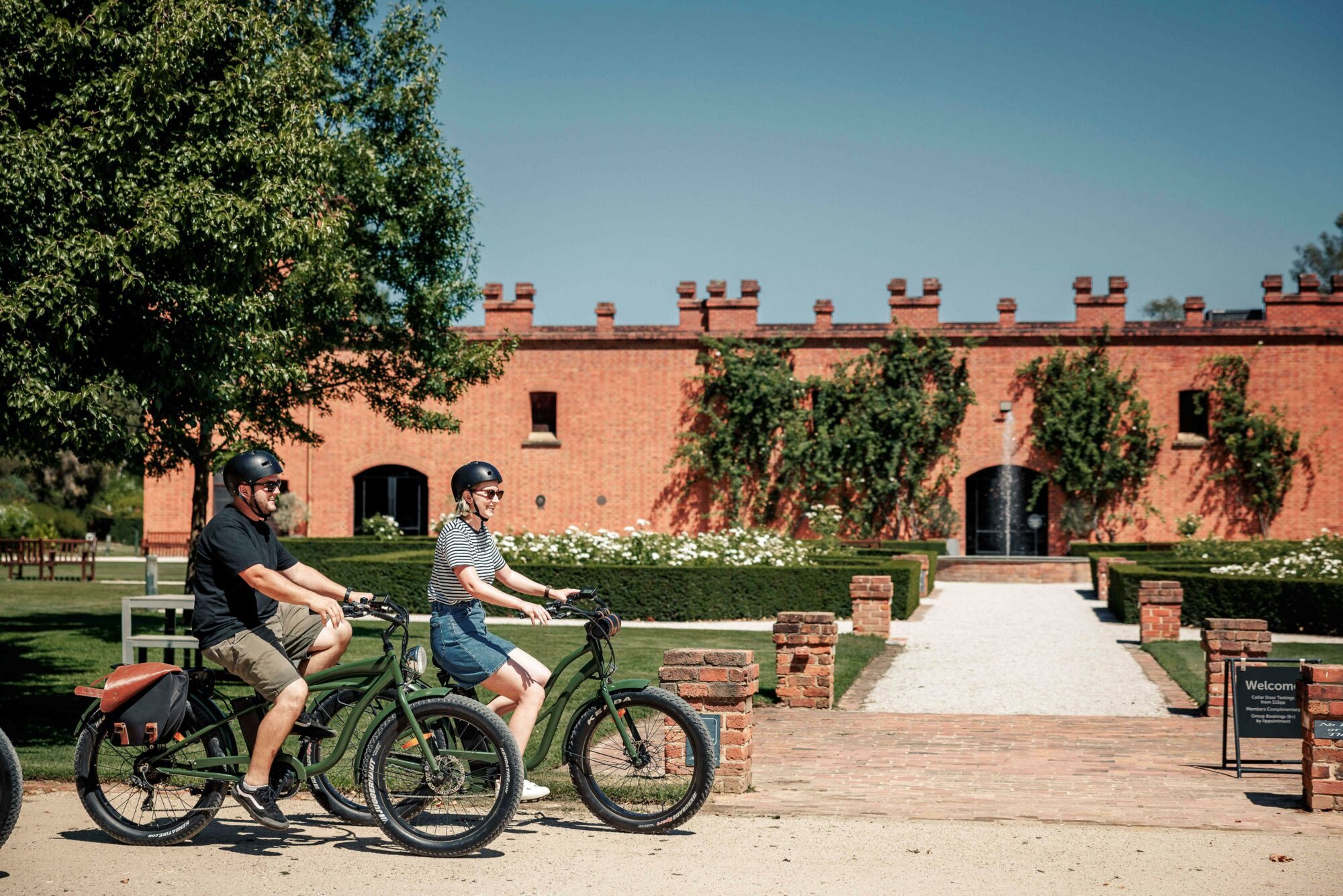 Friends riding e-bikes at All Saints Winery
