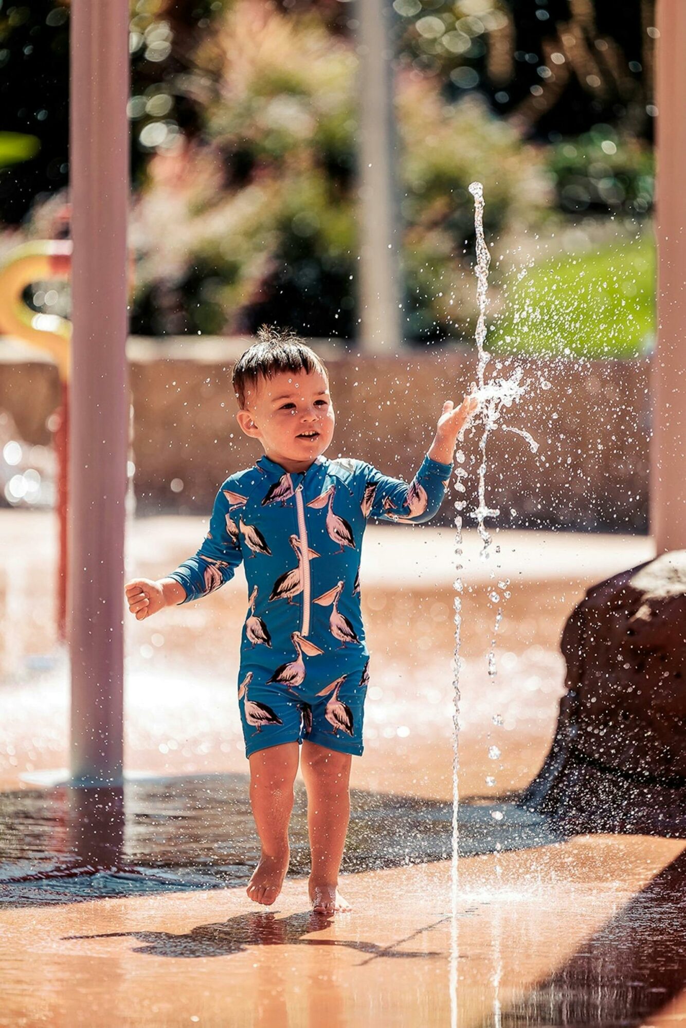 Little boy with blue swimmers at the Benalla Splash Park