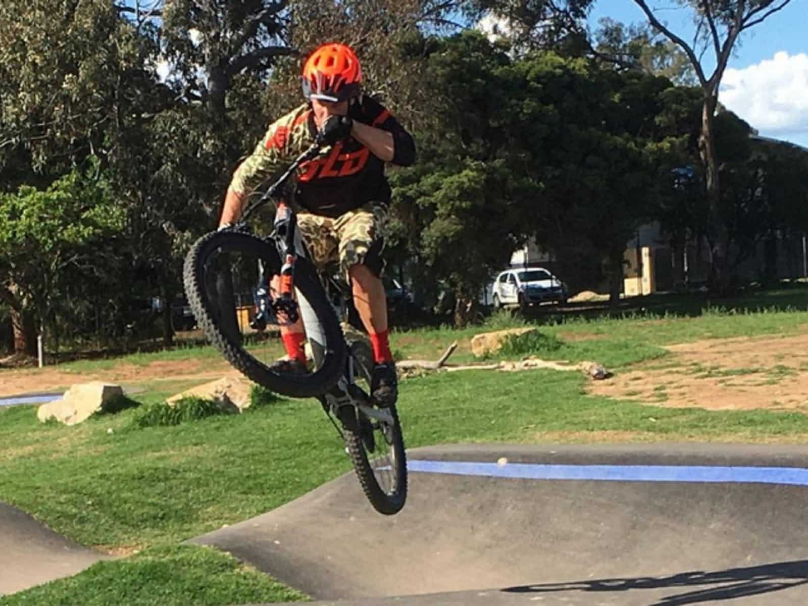 Cyclist in mid air riding the pump track in Mitchell Ave, Wangaratta