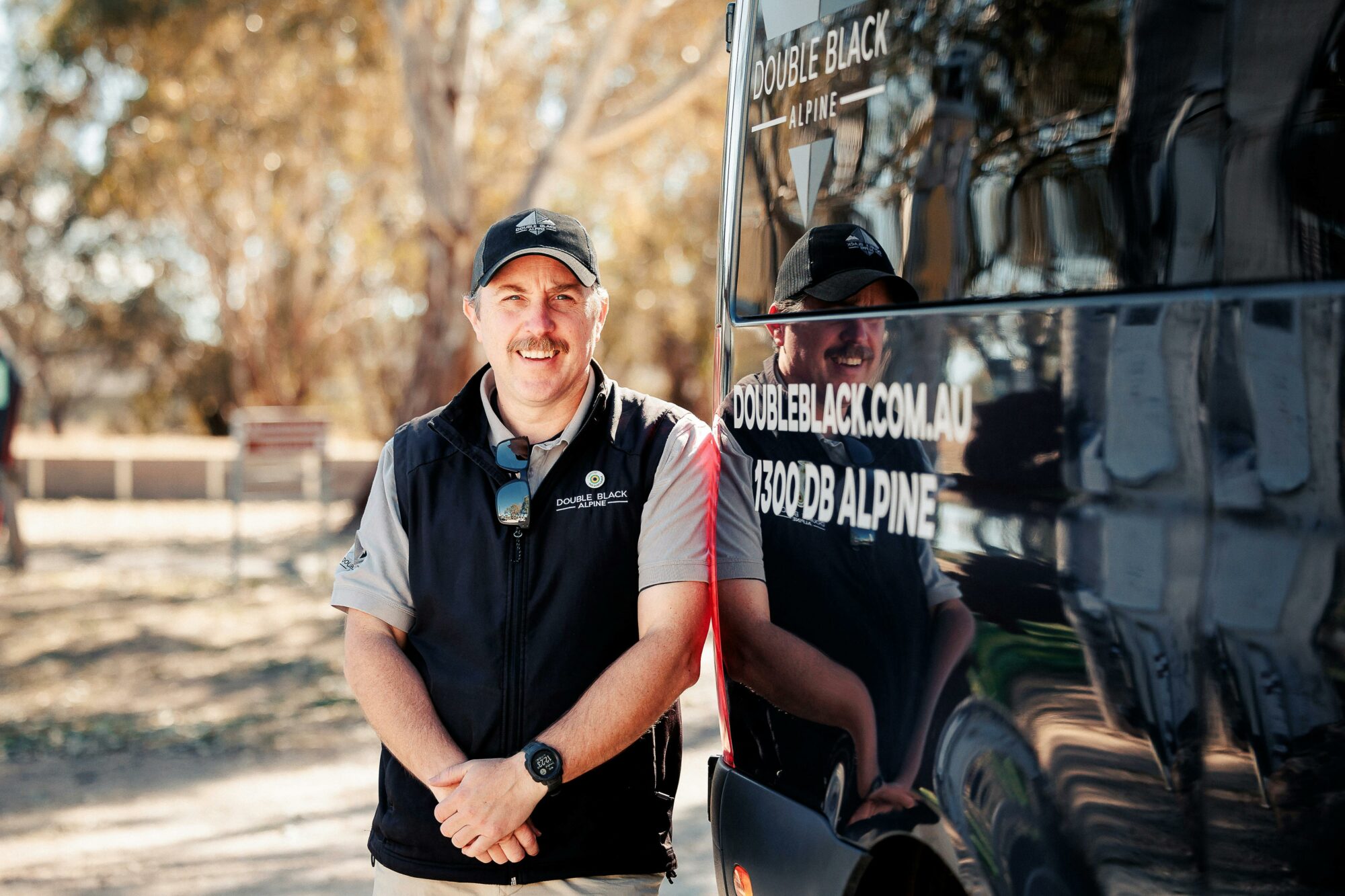 A DBA Team Member is pictured with the vehicle and the Great Victorian Rail Trail in the background.