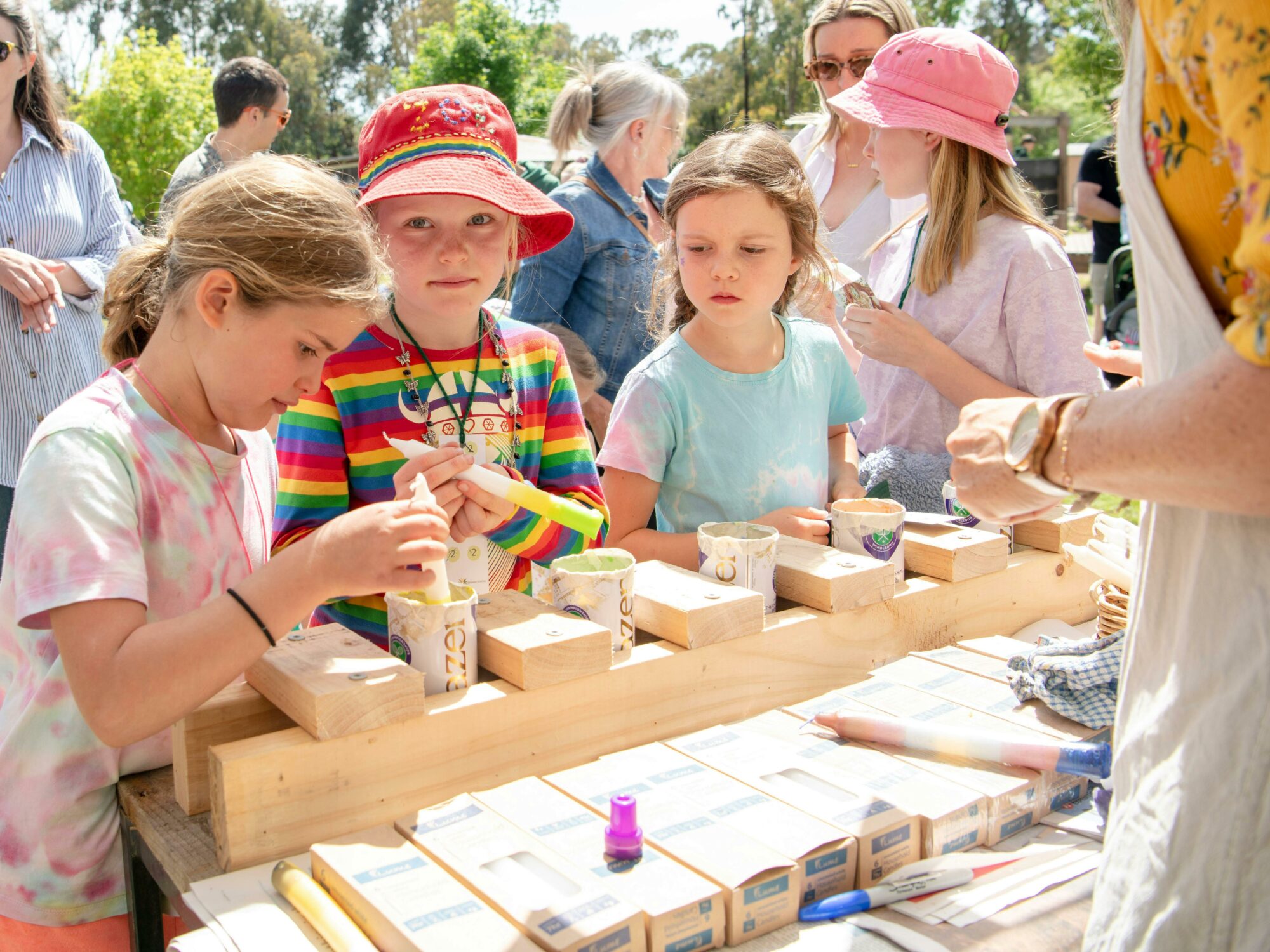 three girls at the candle dipping stall