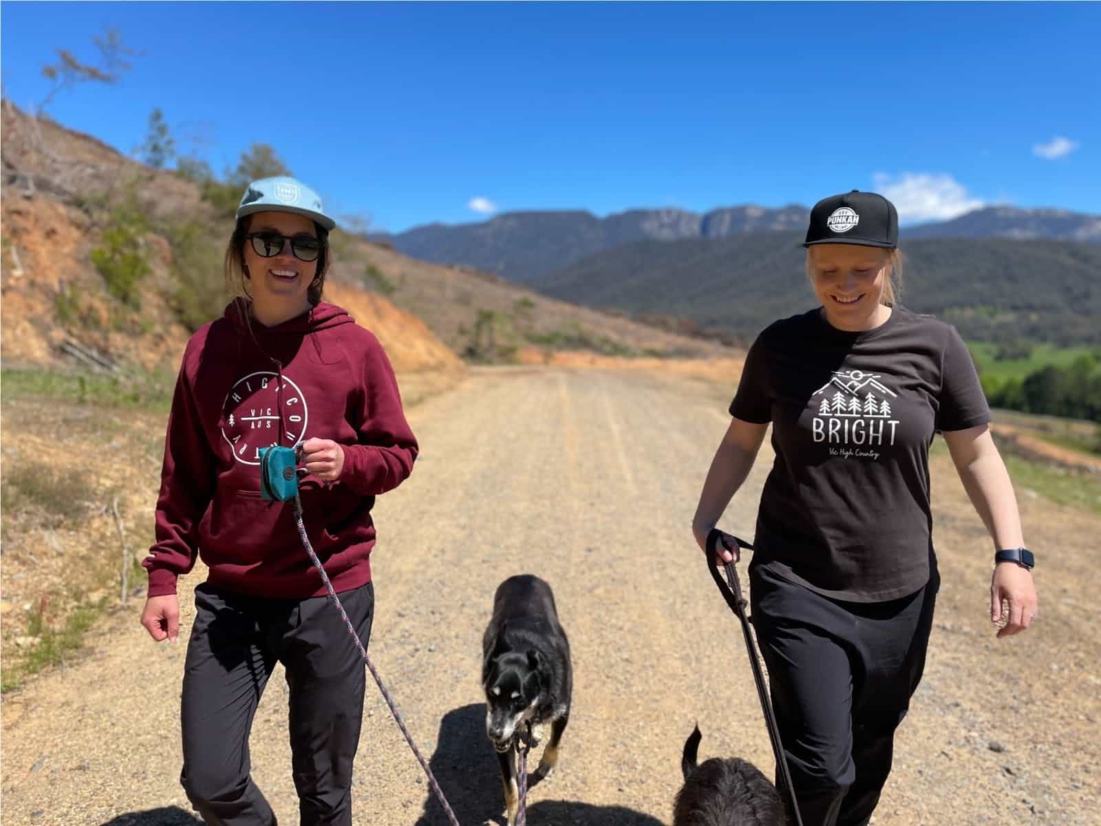 Two ladies walking their dogs in the high country, wearing their own alpine inspired designs.