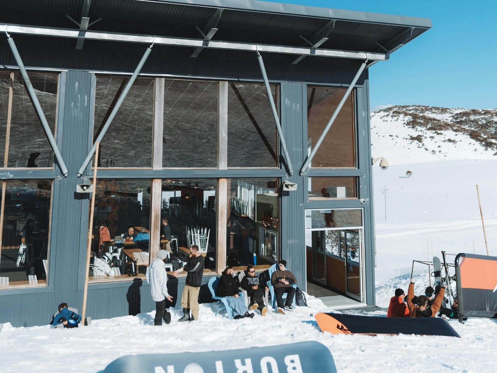 Exterior of Dicky Knees building with friends sitting in the sun