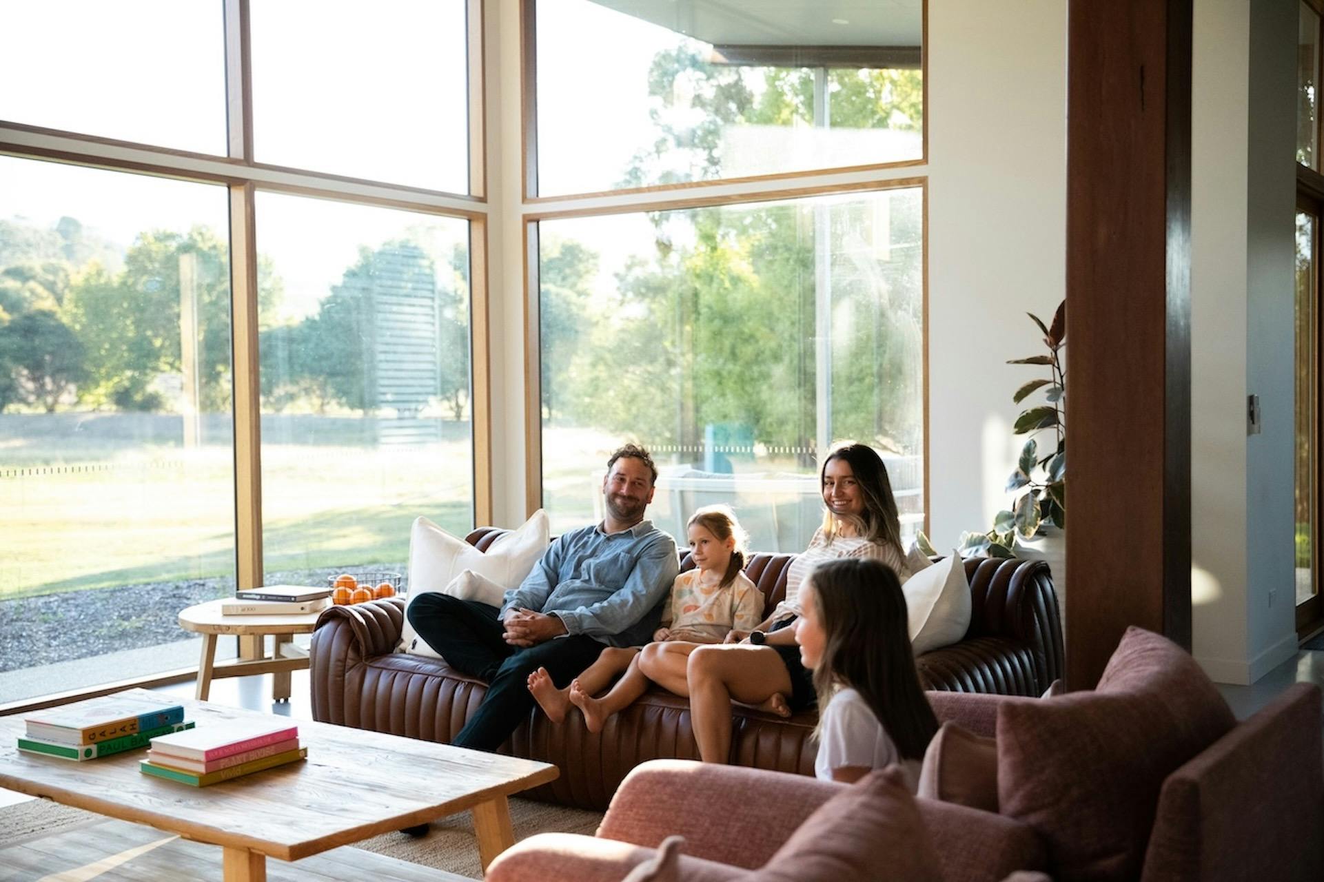 family seated on the living room couch