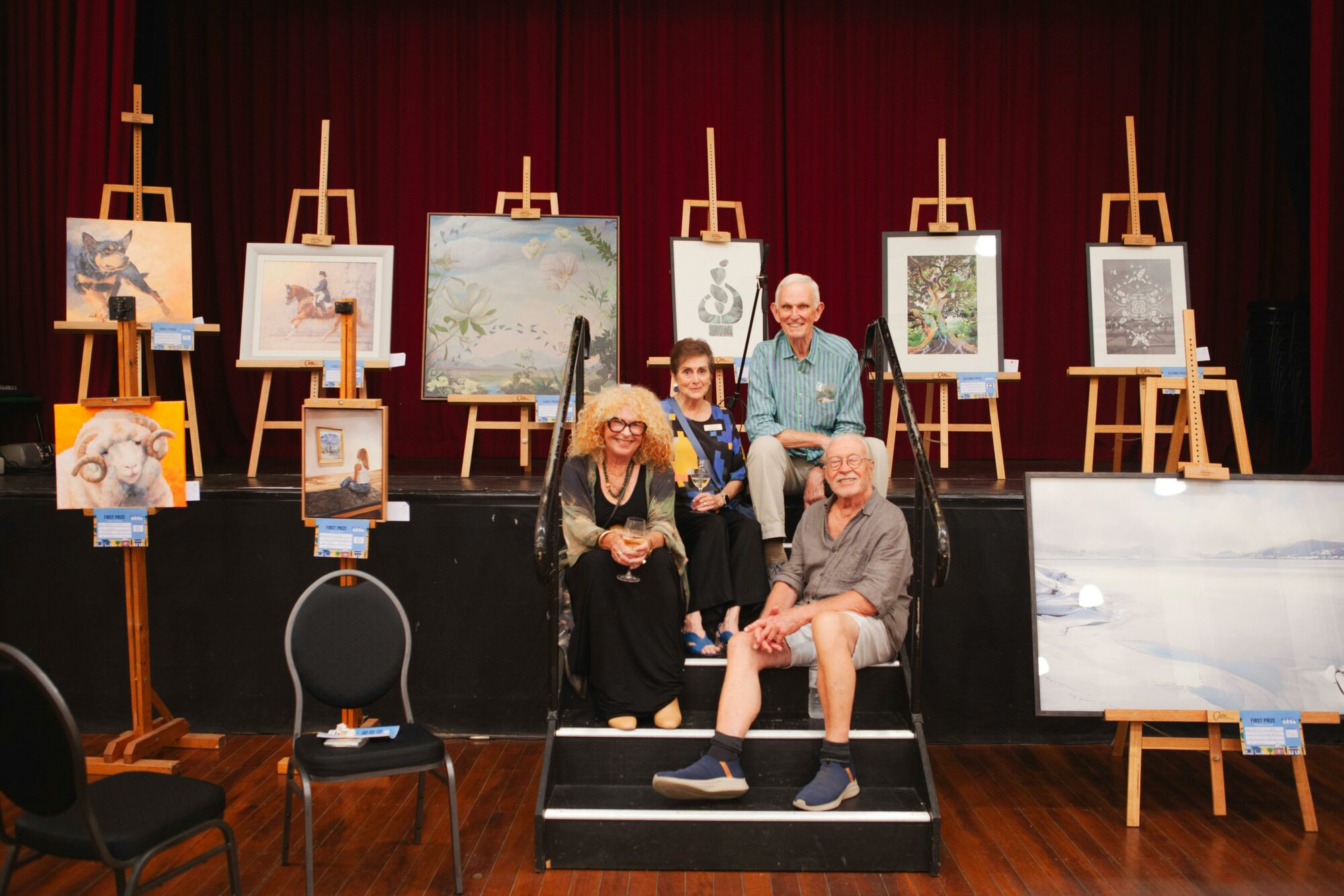 Group of friends sitting in front of the winning art worf