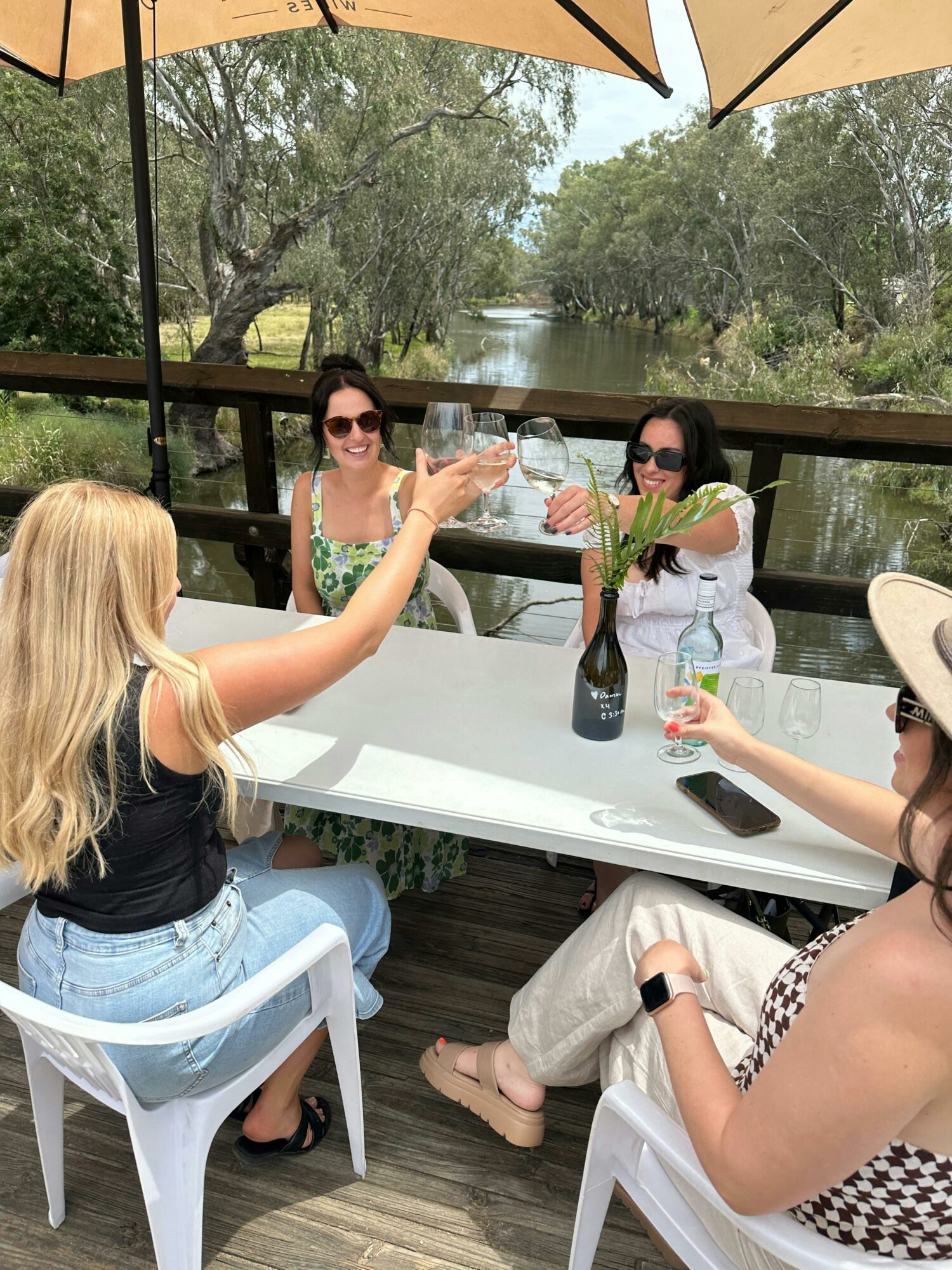 4 girls cheers wine glasses