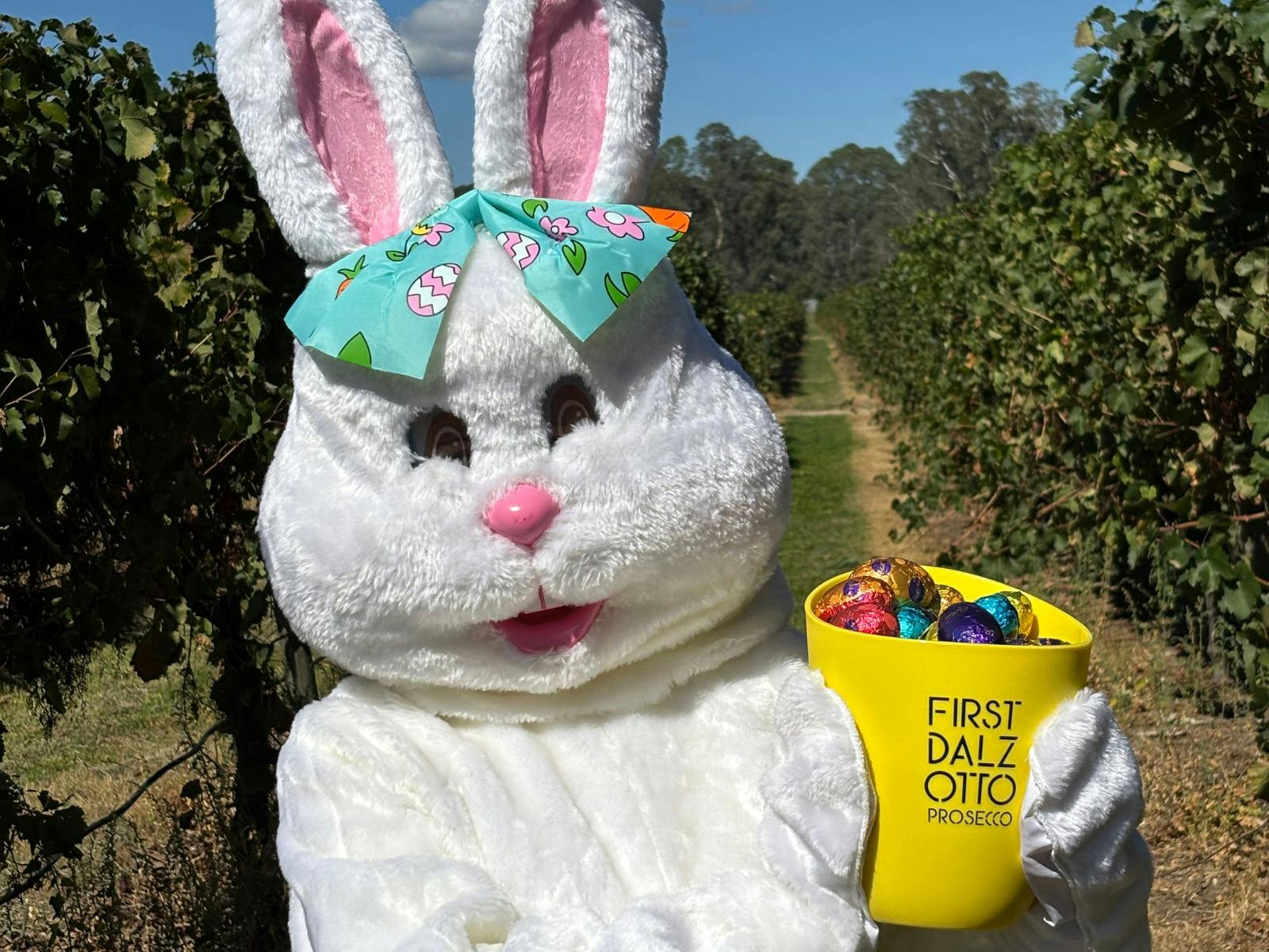 Dal Zotto Wines Easter bunny holding a wine ice bucket full of easter eggs