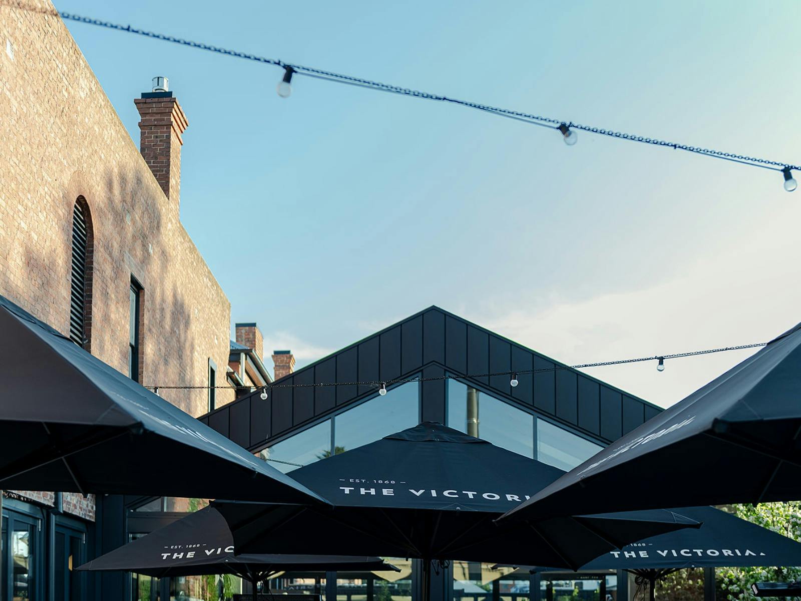 Black umbrellas and a blue sky in the Beer Garden