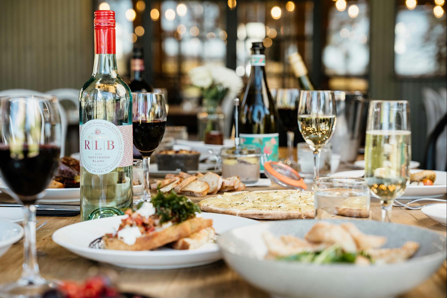A selection of food and wine on a restaurant table.