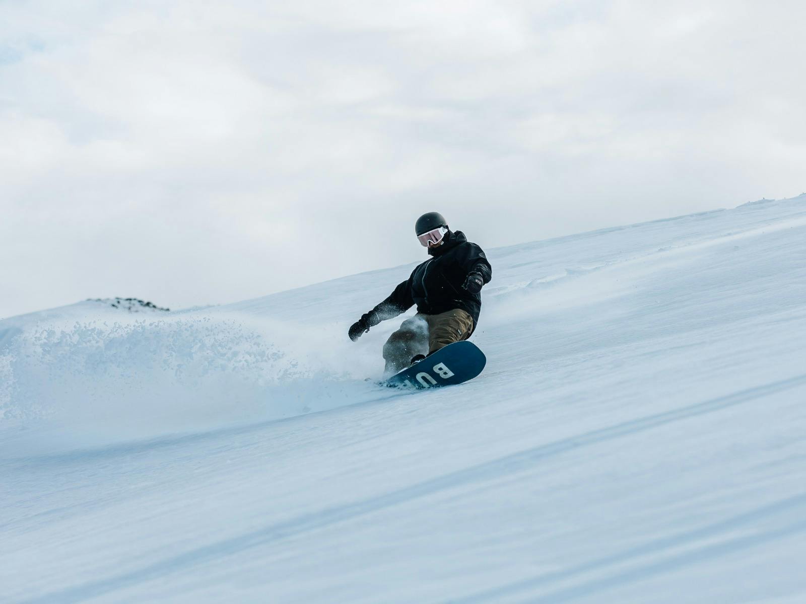 man snowboarding on fresh snow