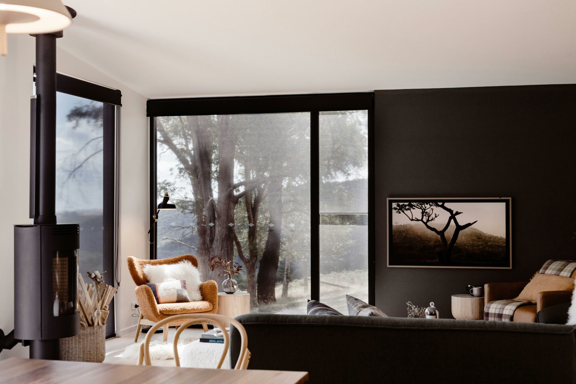 Beautiful ochre armchair in living room with views of mountain in background