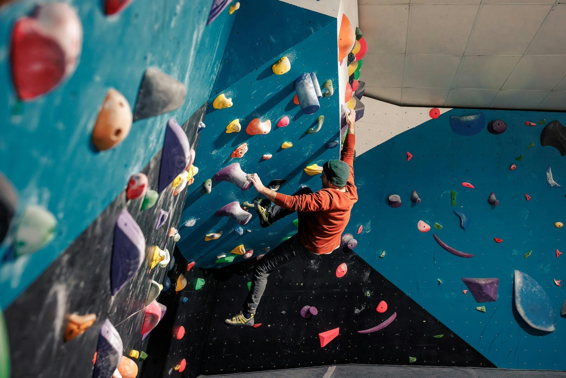 Man bouldering on climbing wall