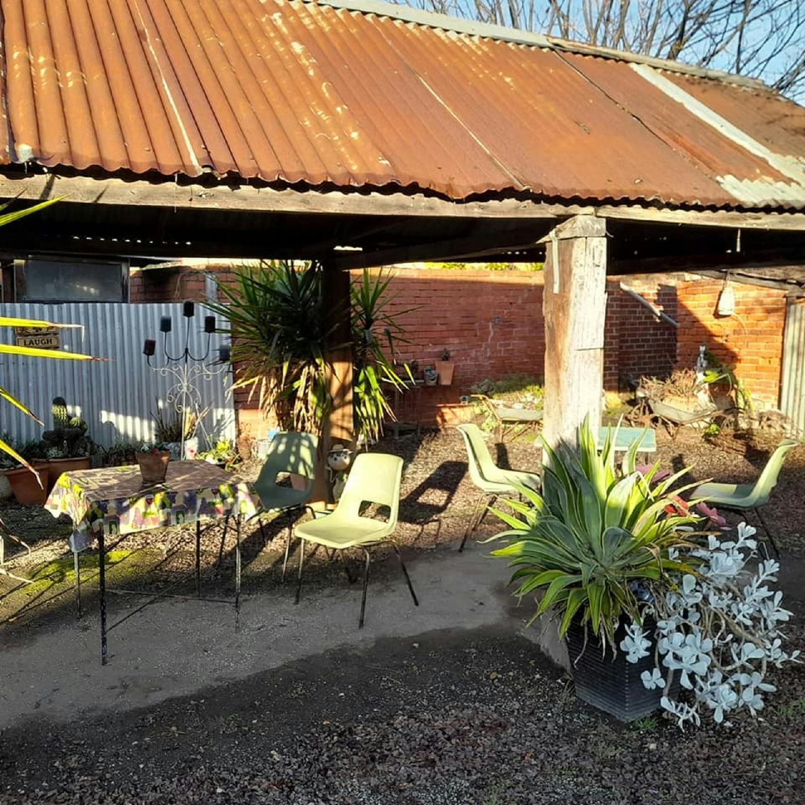 A outdoor seating area within an artists garden