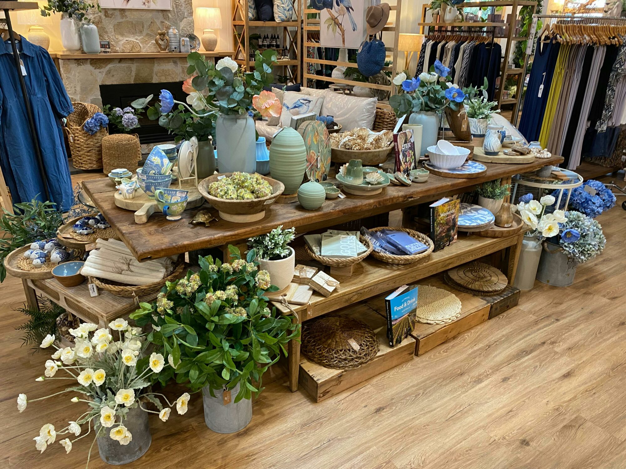 Homewares and fashion items displayed on a shop floor table