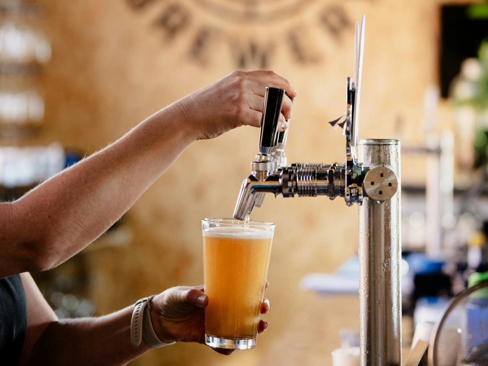 Beer tap, hand pouring craft beer