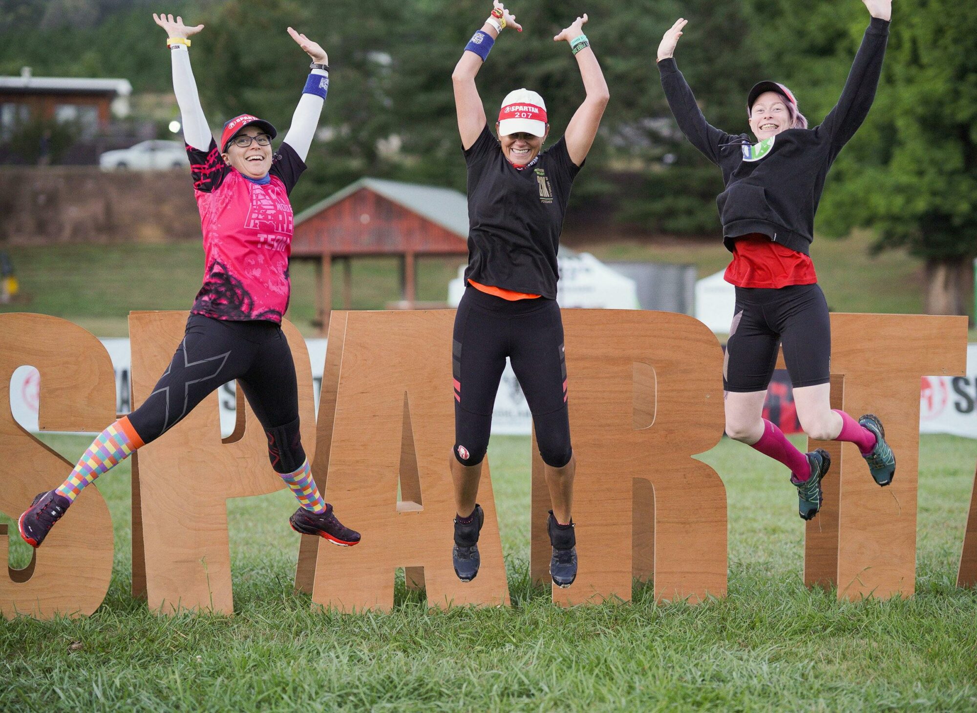 Racers in fromt of spartan sign