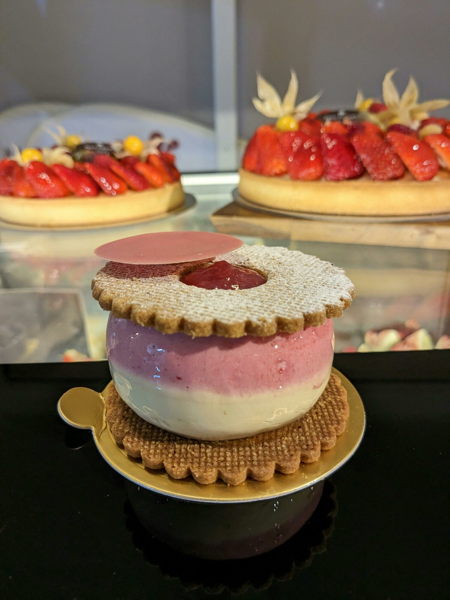 Strawberry and Vanilla Mousse in between 2 biscuits shaped like donuts