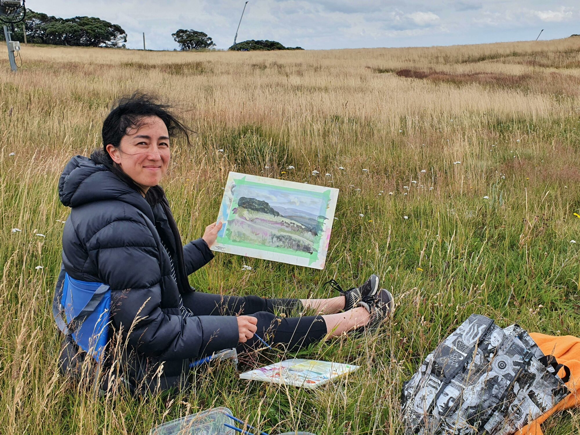 A woman shows off her painting done in Wendy Jagger Studio's workshop.