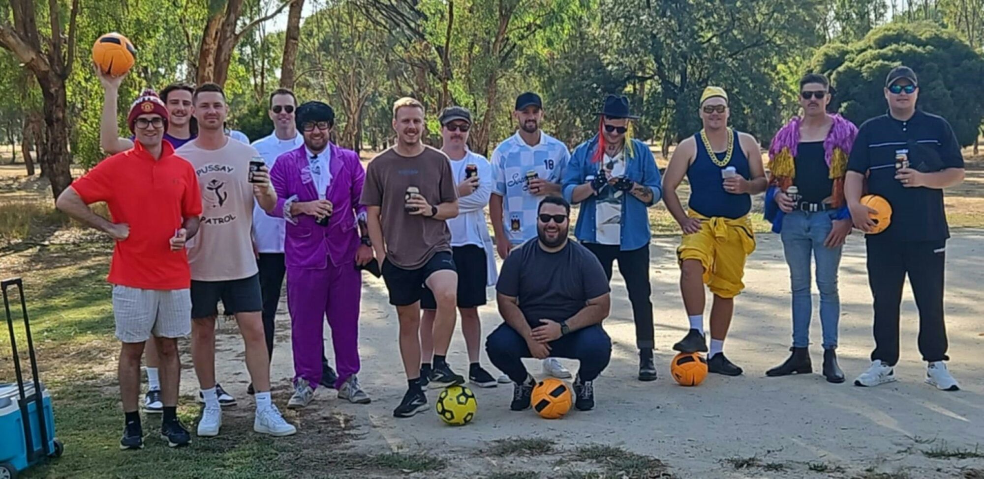 A group of visitors smiling in front of trees in the background