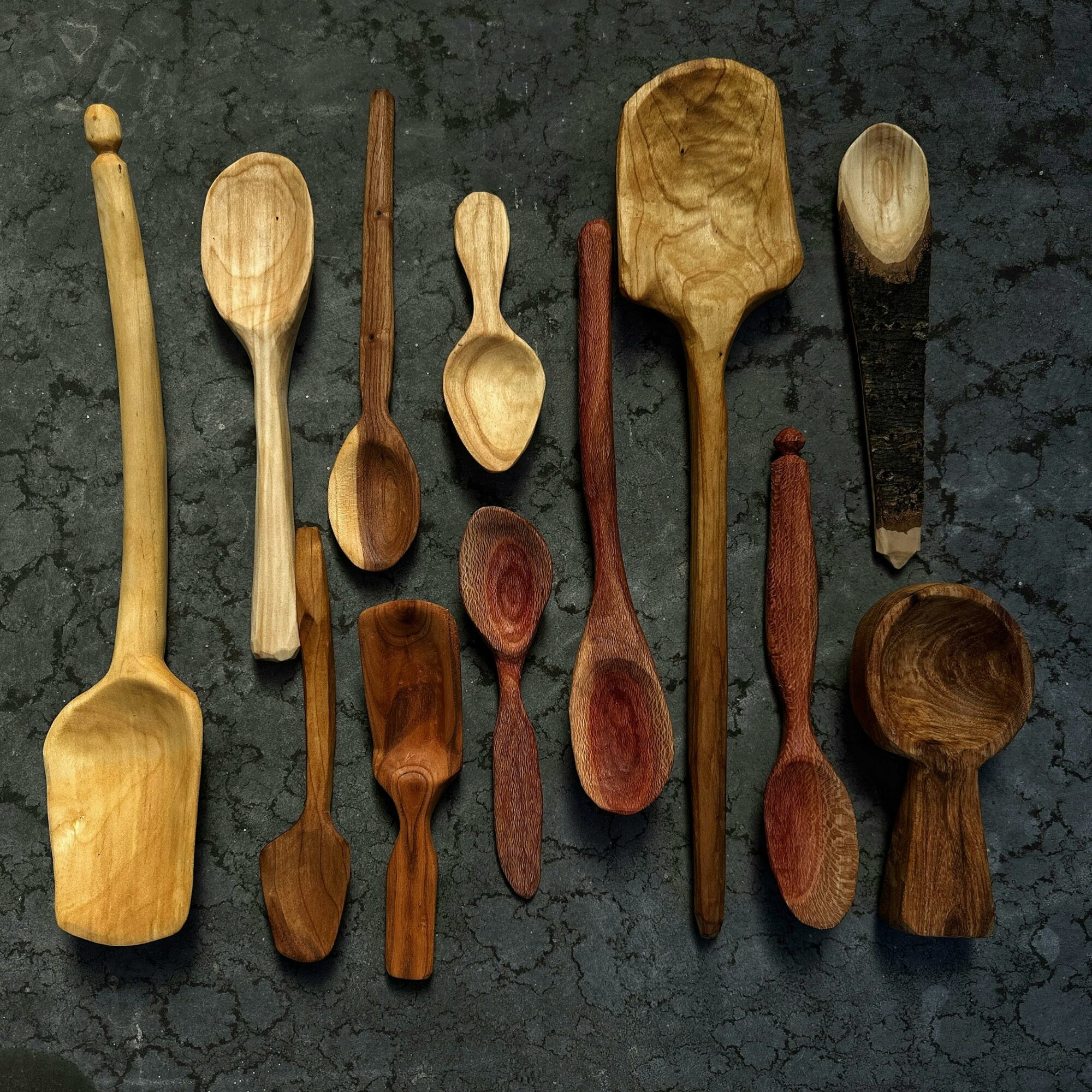 a hand-made wooden spoon with two carving knives
