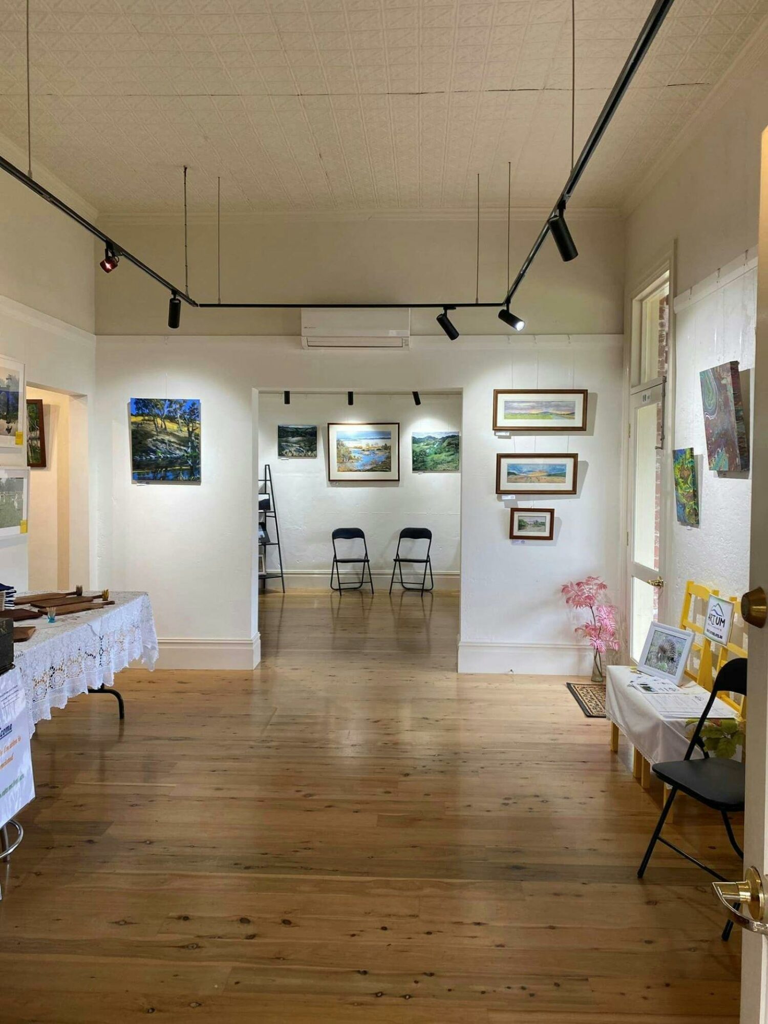 artwork displayed on tables and the wall at Davis Cottage