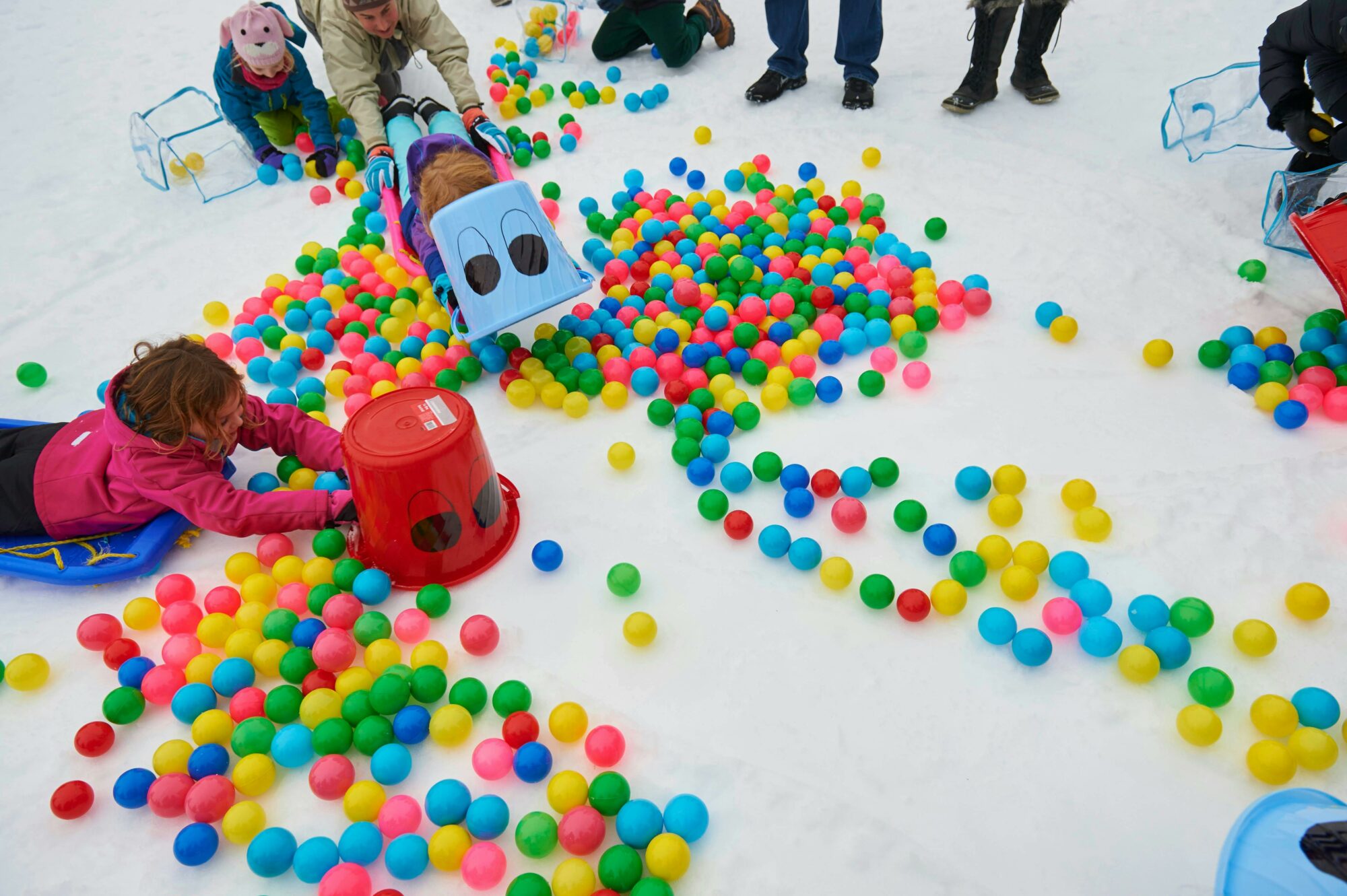 Children Playing with buckets and balls in the snow