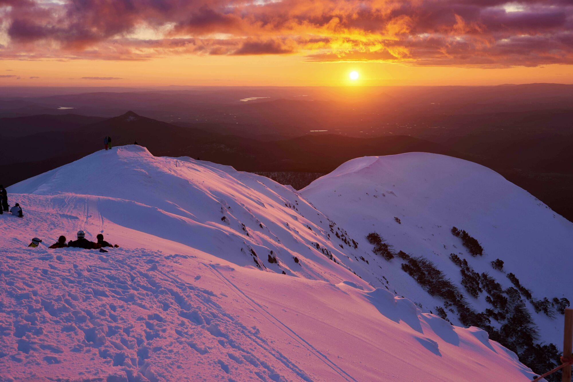 snowy mountains with the sunset in the background